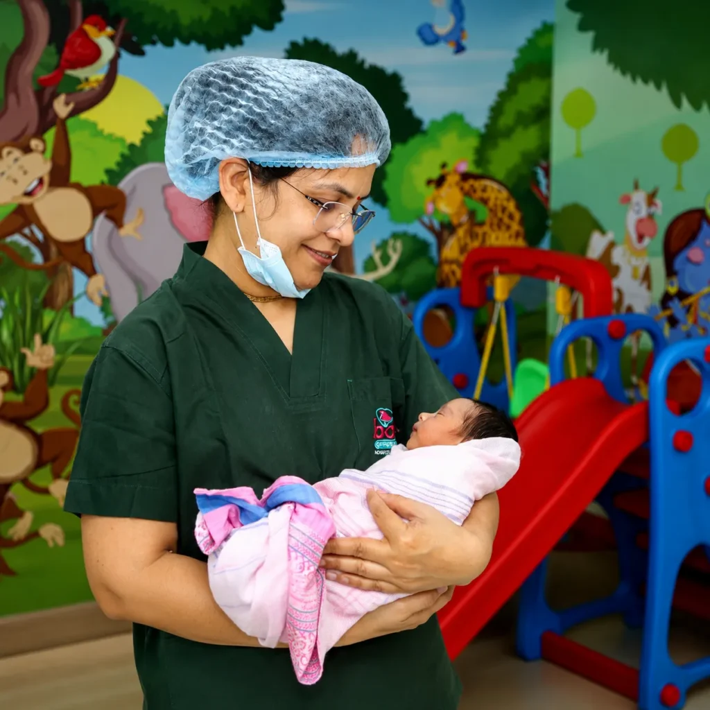 Dr. Vaidehi Deodhar holding a newborn baby in the clinic nursery