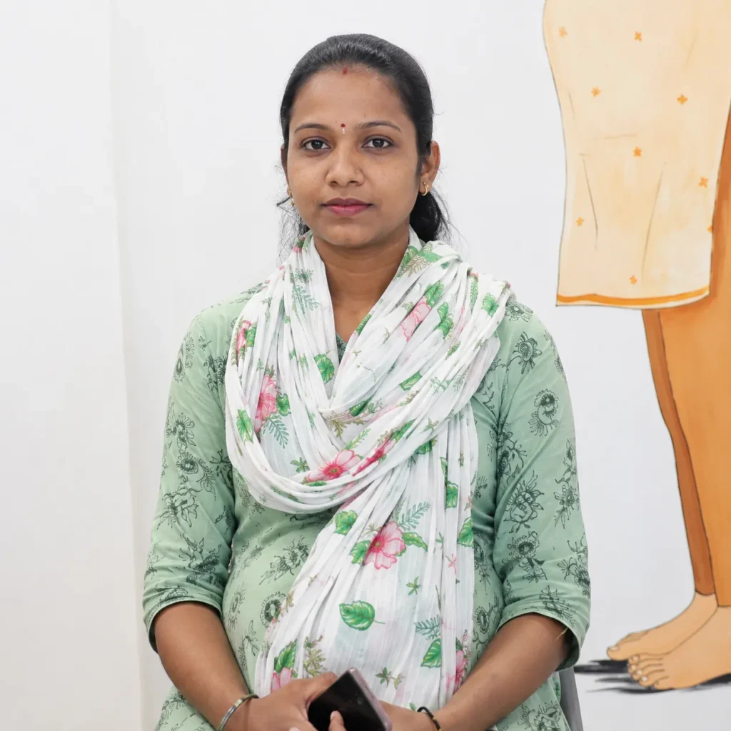 Expectant mother in a green kurta and floral scarf