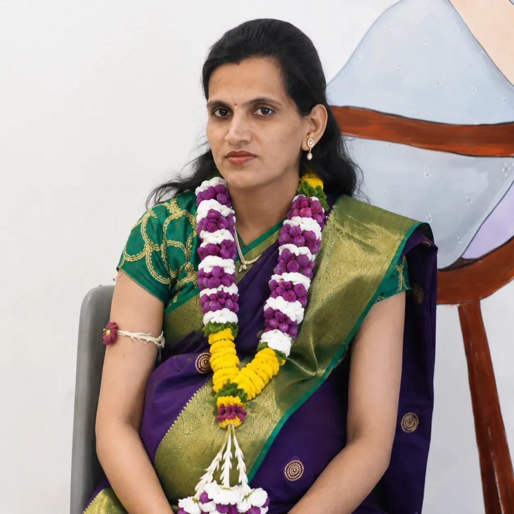 Expectant mother in a silk saree with a flower garland