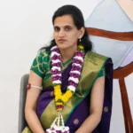 Expectant mother in a silk saree with a flower garland
